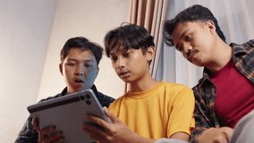 Friends celebrating goal while watching sports streaming on tablet at home. Excitement and joy in cozy living room environment. Sports streaming, tablet watching, cheering goal, team celebration, home - Powered by Shutterstock - Get 15% off with code: PIKWIZARD15