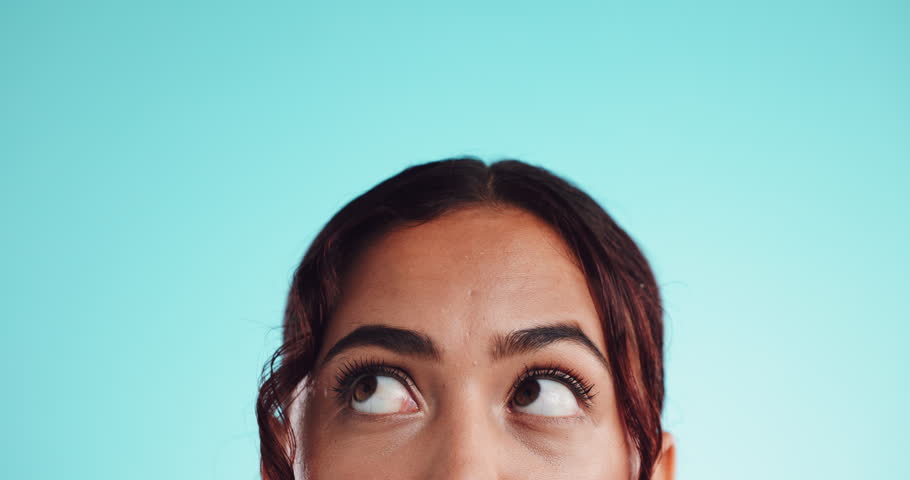 Eyes, thinking and space with woman in studio for choice, remember and brainstorming solution. Decision, mindset and idea with closeup of person on blue background mockup for problem solving