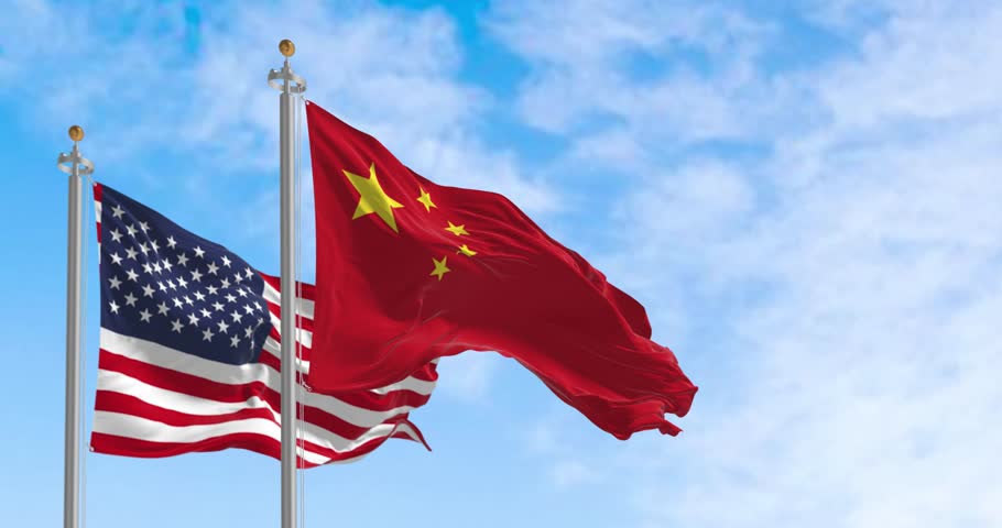 National flags of China and the United States waving in the wind on a clear day. International relationship. Seamless 3d render animation. Slow motion loop. Selective focus