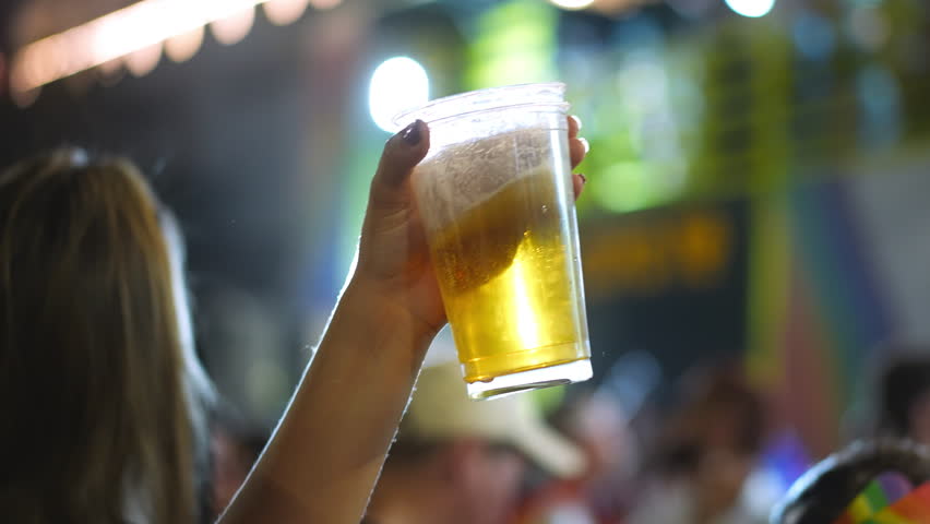 Drunk woman hold craft cold golden ale beer pint close up. Happy rave bar life. Person hang out night club, drink lager closeup. Joy alco rest party. Girl have fun at pub with brew alcohol. Dance fest