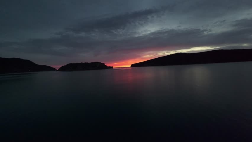 Red sunrise over the sea with islands