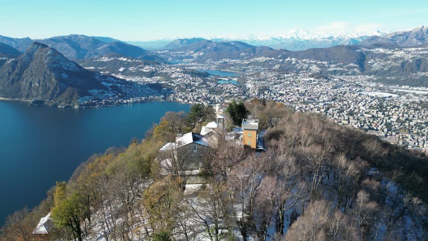 Aerial view of bre mount and st mary church overlooking the beautiful lake and cityscape, lugano, switzerland.