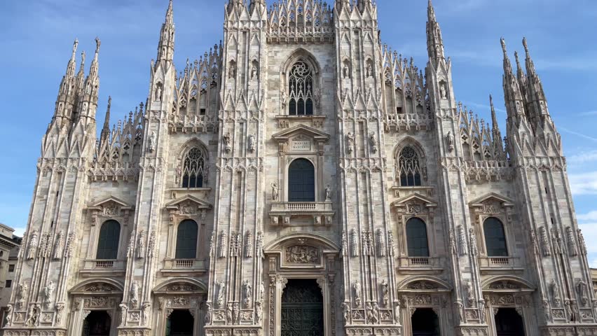 Duomo di Milano Cathedral facade on sunny day. Italian landmark in Town Square. Catholic religion, tourism attraction concepts