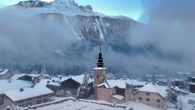 Drone view of Chamonix village in French Alps, alpine village with church bell tower covered with snow, snowy winter landscape in Europe - Powered by Shutterstock - Get 15% off with code: PIKWIZARD15