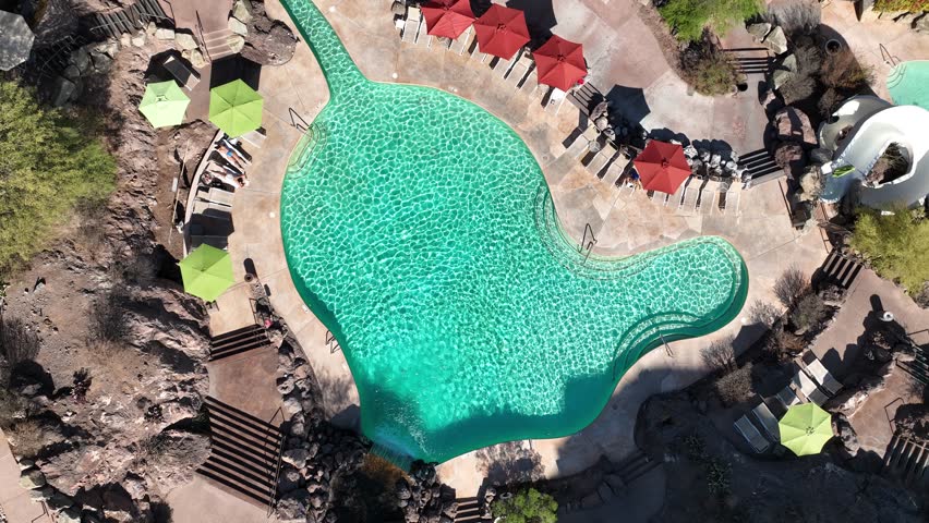 Aerial view of luxury swimming pool with sunbeds and umbrellas at Marriott Phoenix Resort Tempe at the Buttes, Tempe, United States.