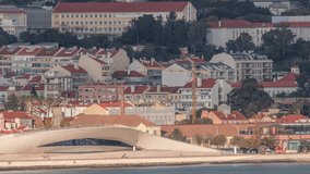 Aerial timelapse of MAAT (Museum of Art, Architecture, and Technology) on the Tagus River waterfront in Lisbon's Belem district. Scenic views include historical houses and construction site cranes - Powered by Shutterstock - Get 15% off with code: PIKWIZARD15