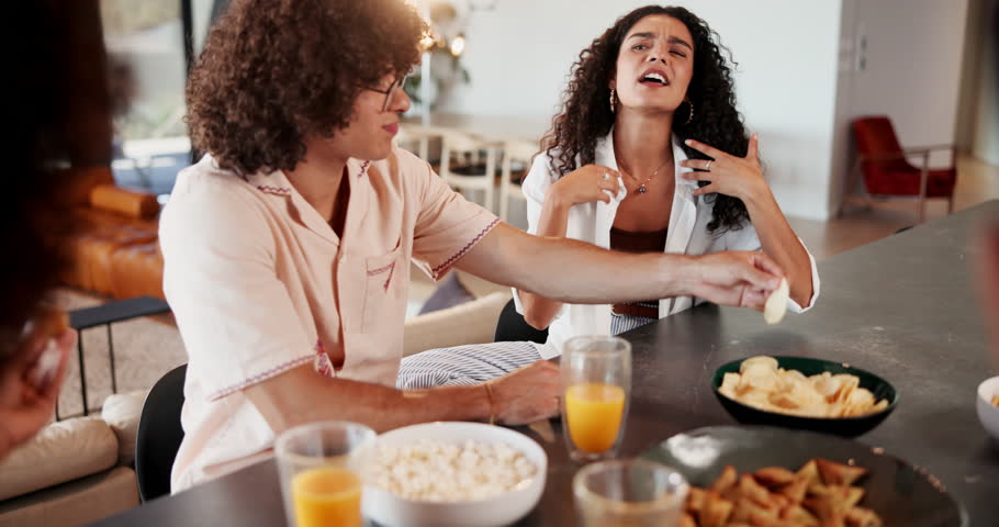 Happy, friends and eating with snacks in kitchen for morning conversation, social gathering or chat at home. People, group or friendly community with food or drinks for fun get together at house
