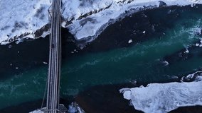 Aerial top down of cars on Bridge over Selfoss River with ice floe in winter. Snowy winter landscape in Iceland. - Powered by Shutterstock - Get 15% off with code: PIKWIZARD15