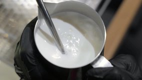 Barista steaming milk in a metal pitcher, Close-up of steamed milk being prepared with a frothing wand. - Powered by Shutterstock - Get 15% off with code: PIKWIZARD15