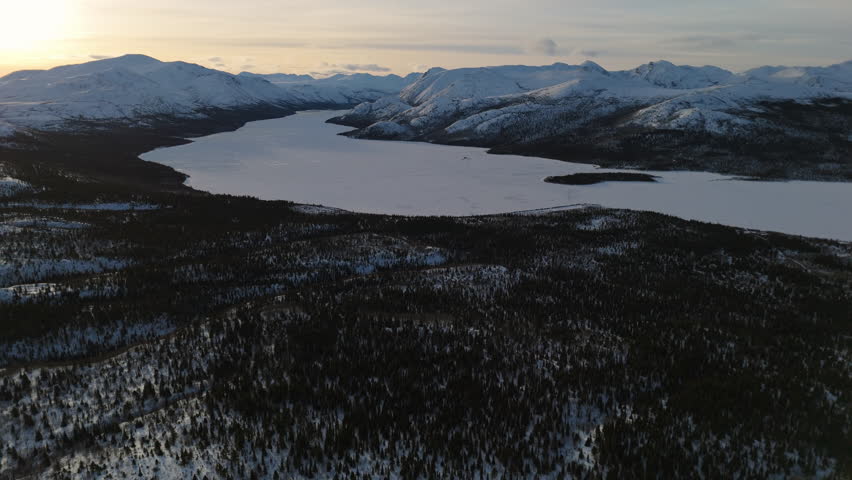 A serene aerial view of Fish Lake in Whitehorse, Yukon. The below-zero temperatures transform the Canadian Northern Territory into a stunning winter paradise.