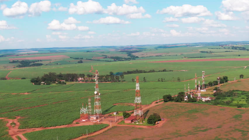 Drone aerial landscape of communications towers antennas infrastructure network systems installation equipment in farmland rural countryside Brazil South America industry technology.