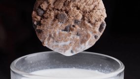 Chocolate chip cookie dipped in a glass of milk. - Powered by Shutterstock - Get 15% off with code: PIKWIZARD15