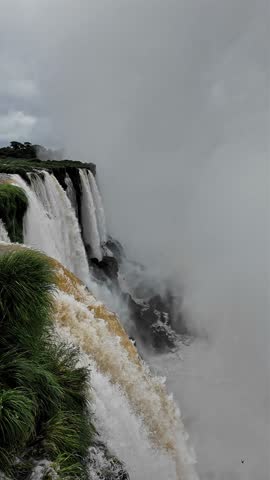 Stunning vertical video format showcasing Iguazu Falls on the Argentina-Brazil border. Witness the power of the upper and lower Iguazu River in Misiones Province, the largest waterfall system on Earth