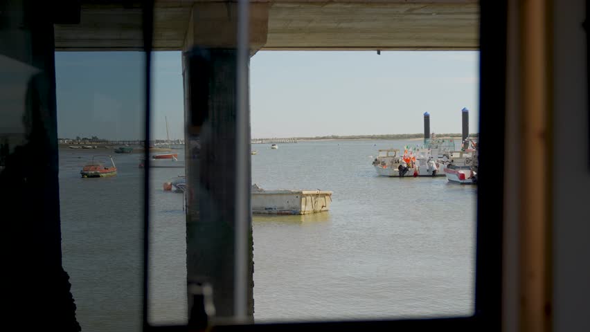 El Rompido, small boats on the Piedras River. views from the window of a gently rocking fishing boat. slow motion video 50 fps. 4k quality