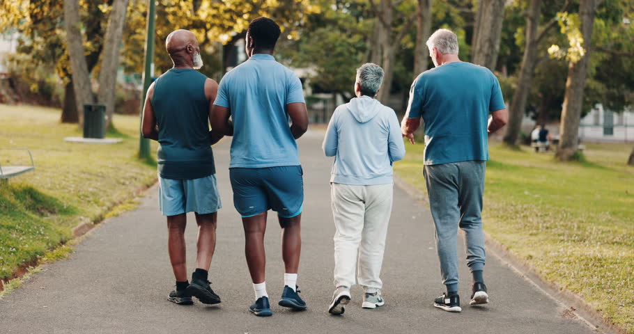 People, back or walking with coach for fitness, cardio workout or outdoor exercise together at park. Talking, runners or healthy friends with personal trainer, group and wellness on path in nature