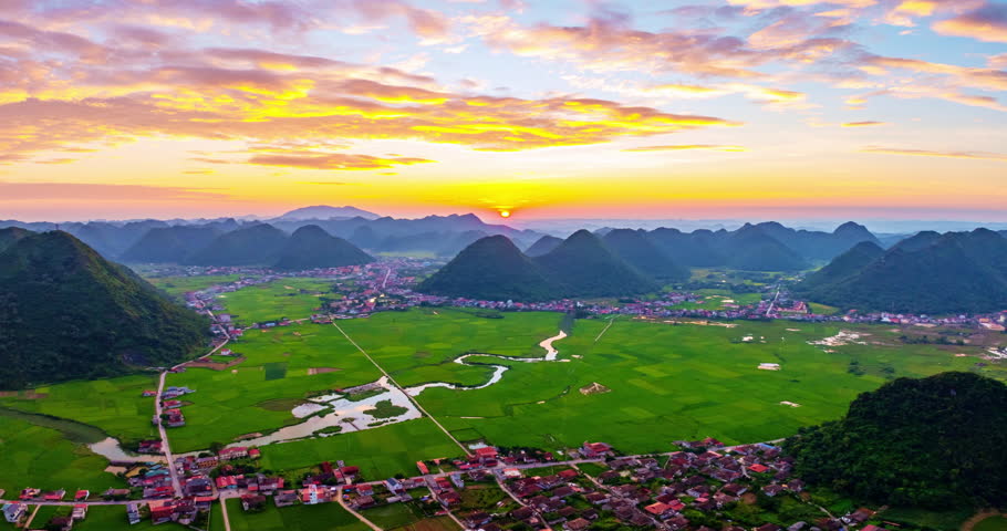 Amazing Drone aerial view Hyperlapse of landscape mountains view with clouds flowing over mountains,High angle view sunset colorful clouds over countryside at northern Vietnam