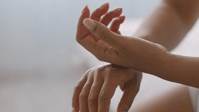 A young African American woman engages in her skincare routine, applying cream to her hand in her cozy home. She embraces self-care, enhancing her natural beauty and well-being. - Powered by Shutterstock - Get 15% off with code: PIKWIZARD15
