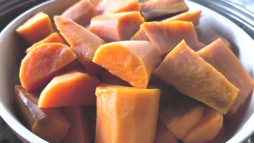 Steaming  sweet potatoes in pot, in door  Chiangmai  Thailand.