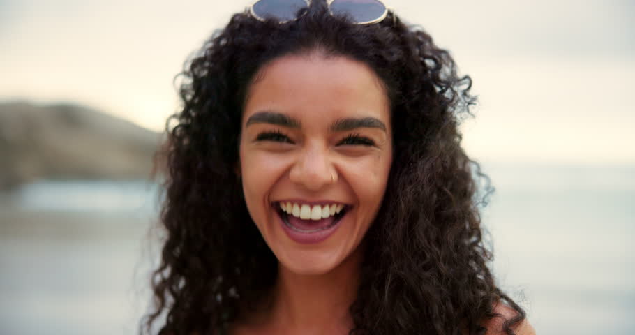 Woman, face and blow kiss on beach for travel, freedom and expression for Valentines day. Girl, pout or relax at ocean with smile, photography and gesture for online dating profile on summer vacation