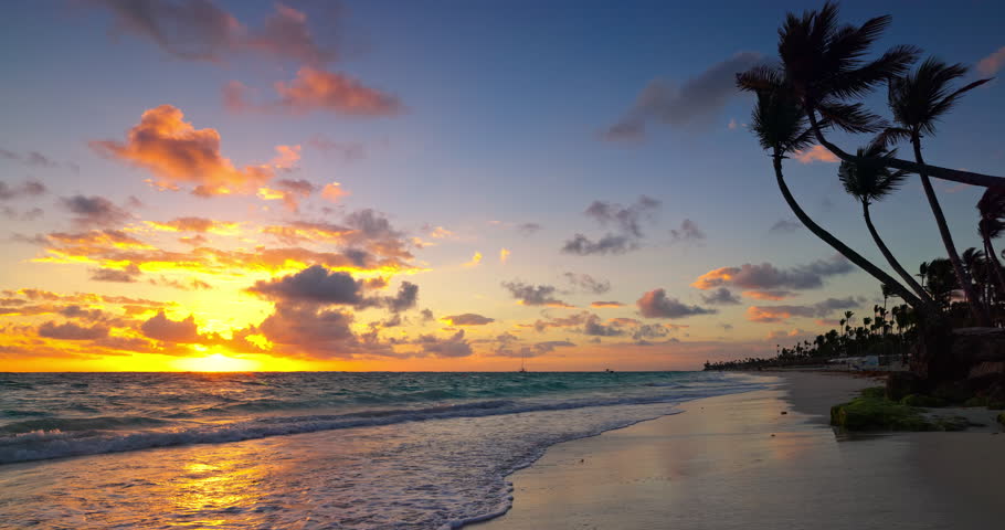 Paradise landscape of ocean shore exotic beach palms sunrise over Punta Cana, La Romana, Dominican Republic