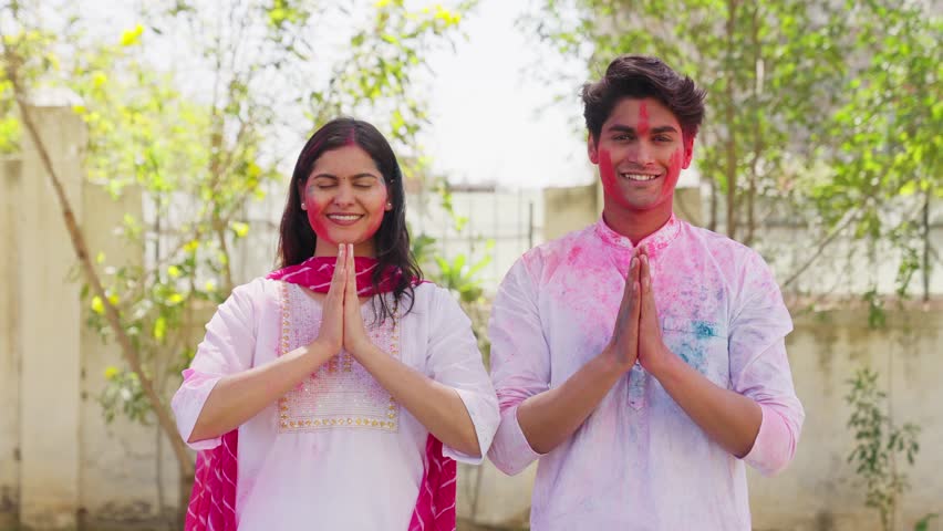 Indian Couple Greeting Namaste on Holi Festival