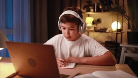 Portrait of cute little boy studying using laptop computer and looking at screen at home Adorable multiethnic kid child doing homework alone late at night indoors Distance online education - Powered by Shutterstock - Get 15% off with code: PIKWIZARD15