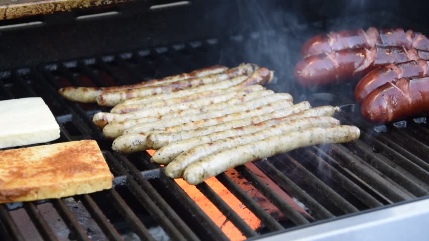 Sausages being cooked on the grill.