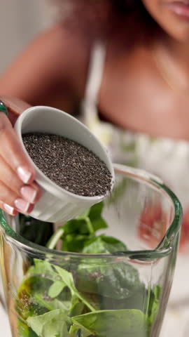 Blender, ingredients and seeds with woman in kitchen of home to prepare smoothie for diet. Health, nutrition and recipe with vegan person in apartment for cooking, detox or weight loss beverage