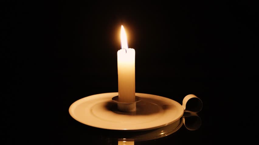 A candle being blown out on a black background. A concept of electricity crisis in South Africa.