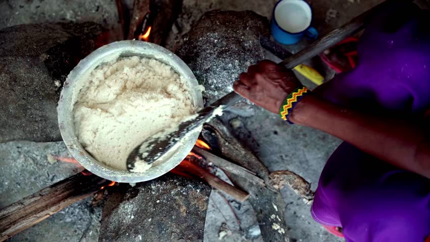 African woman cooking ugali with finger millet flour