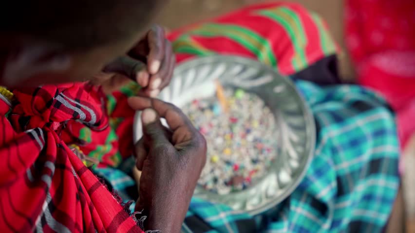 African woman handcrafting Maasai jewelry