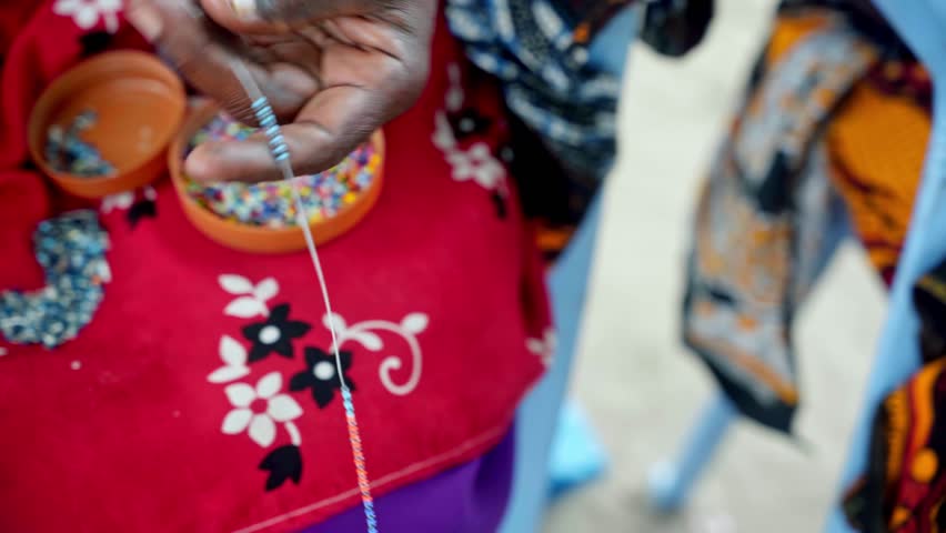 African artist handcrafting Maasai jewelry