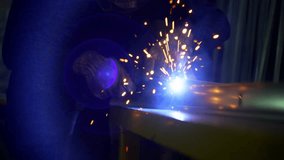 Industrial Welder in Protective Gear Welding Metal Profiles Together with High Precision in a Factory Workshop for Heavy-Duty Manufacturing and Fabrication. High quality 4k footage - Powered by Shutterstock - Get 15% off with code: PIKWIZARD15