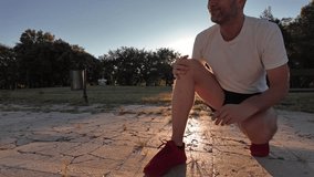 Man with injured and painful knee during jogging and exercise in a park. - Powered by Shutterstock - Get 15% off with code: PIKWIZARD15