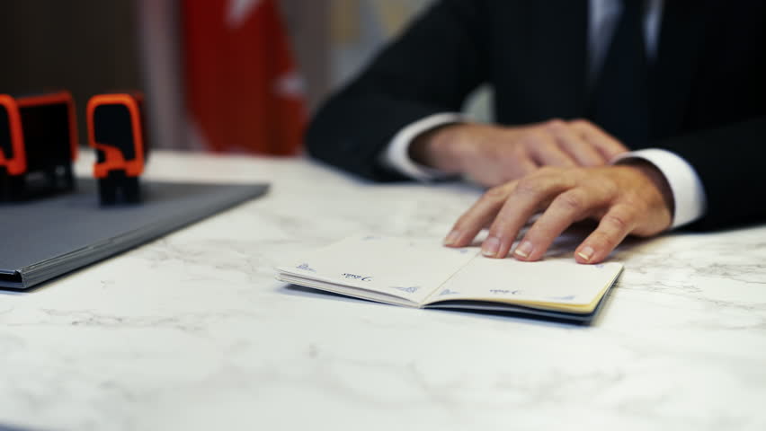 Canadian customs officer stamps denied in a passport, refusing traveler's entry