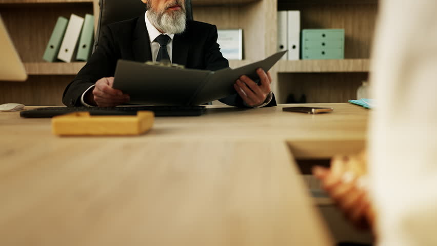 HR manager reviews a CV and rejects a candidate during a tense job interview