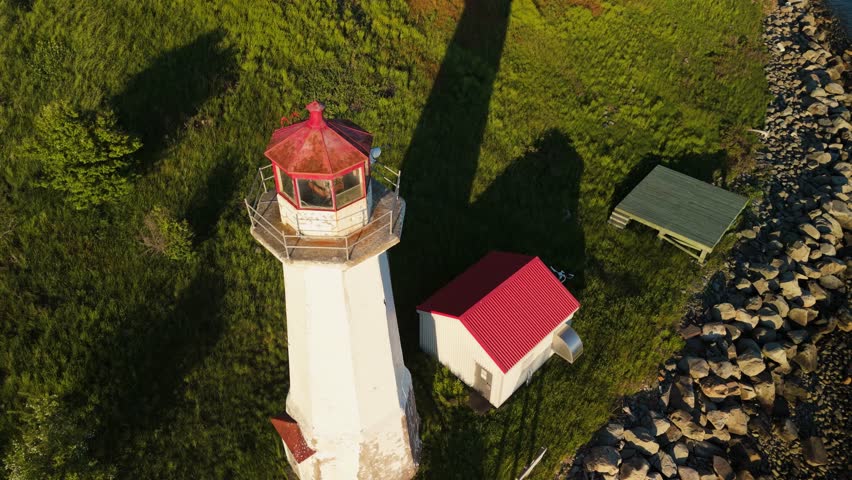 A Breathtaking Aerial Footage Of An Ancient Lighthouse Located On A Small Island In Halifax Harbor, Nova Scotia. The Sunset Adds A Touch Of Magic To The Historic Landmark. 