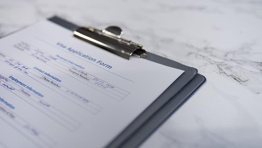Visa application form gets rejected as a hand stamps a denied seal on document