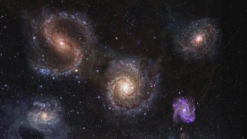 Galaxies against a backdrop of stars in deep space.