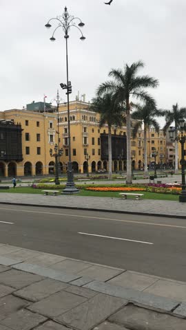 View of main square of Lima in Peru. Municipal Palace, fountain, palm trees and cathedral church.Plaza Mayor or Plaza de Armas of Lima in the Historic Center of town, surrounded by colonial buildings.