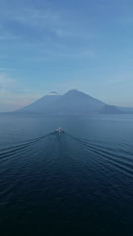 Boat crossing Atitlan lake facing Atitlan and Toliman volcanos