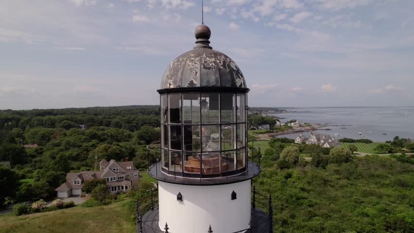 Historic lighthouse with ocean and coastal homes in Cape Elizabeth, Maine