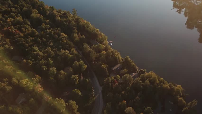 aerial top down of Lake Placid in the Adirondack Mountains in Essex County, New York, United States, drone footage flying above lake and natural pine tree green forest