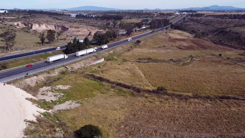 Drone Footage of Trailers Carrying Goods on Busy Freeway, Mexico