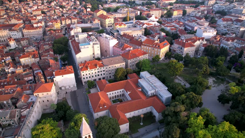Historic aerial view of Split, Croatia, with red-roofed buildings and green spaces