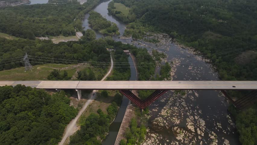 Cars traveling over a bridge, over the Shenandoah River in West Virginia.
