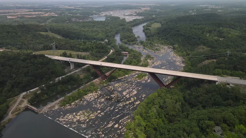 Bridge over the Shenandoah River. Dense green forest. View from above.
