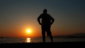 Tourist man silhouette against dusk ocean. A male traveler silhouette enjoy the dusk horizon during summer trip. - Powered by Shutterstock - Get 15% off with code: PIKWIZARD15