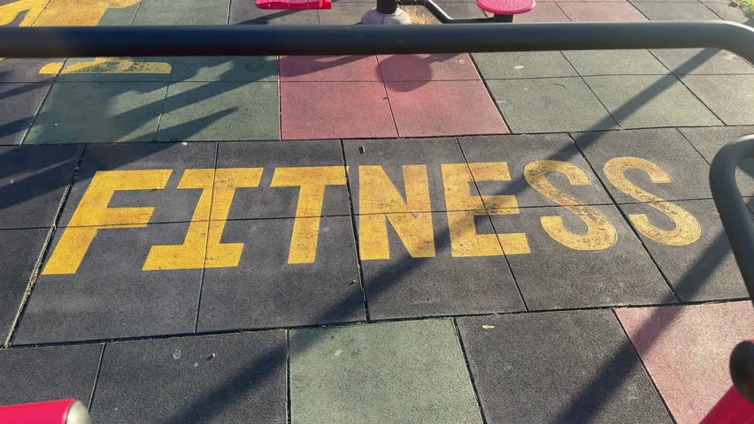 A mural of the word Fitness painted on the floor of an outdoor gym in Cape Town.