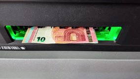 Close-up view then withdrawing euro banknotes from ATM after accepted, France. - Powered by Shutterstock - Get 15% off with code: PIKWIZARD15